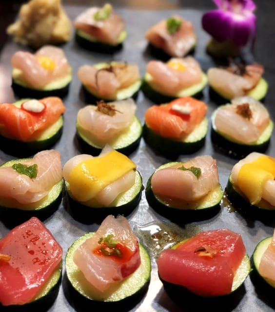 assorted sashimi on cucumber slices